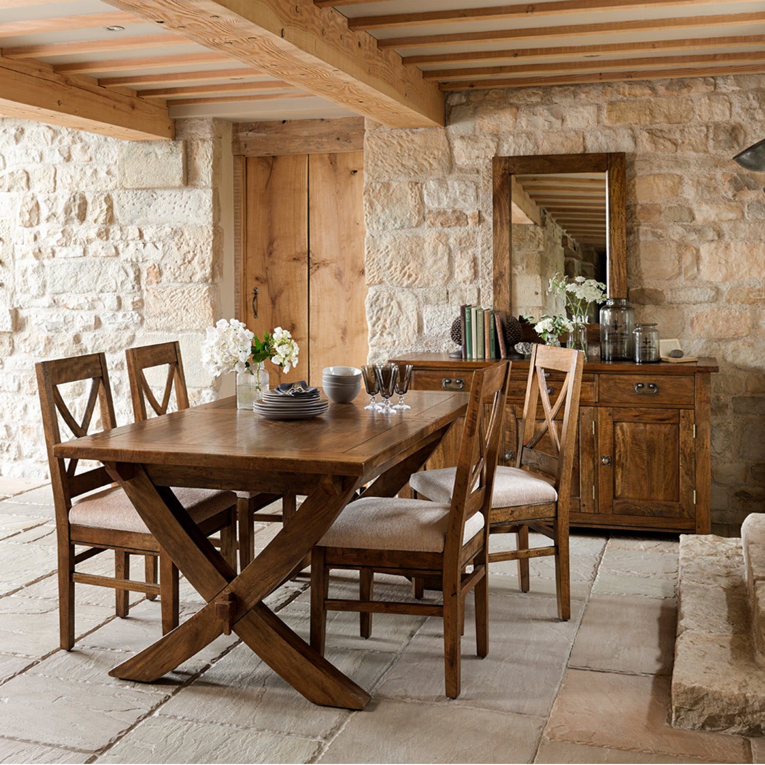 Chateau Leg Extension Dining Table crafted from solid mango wood, styled in a rustic dining room.