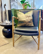 Coco Occasional Chair in black leather with a sculpted solid timber frame and contemporary Scandinavian design.