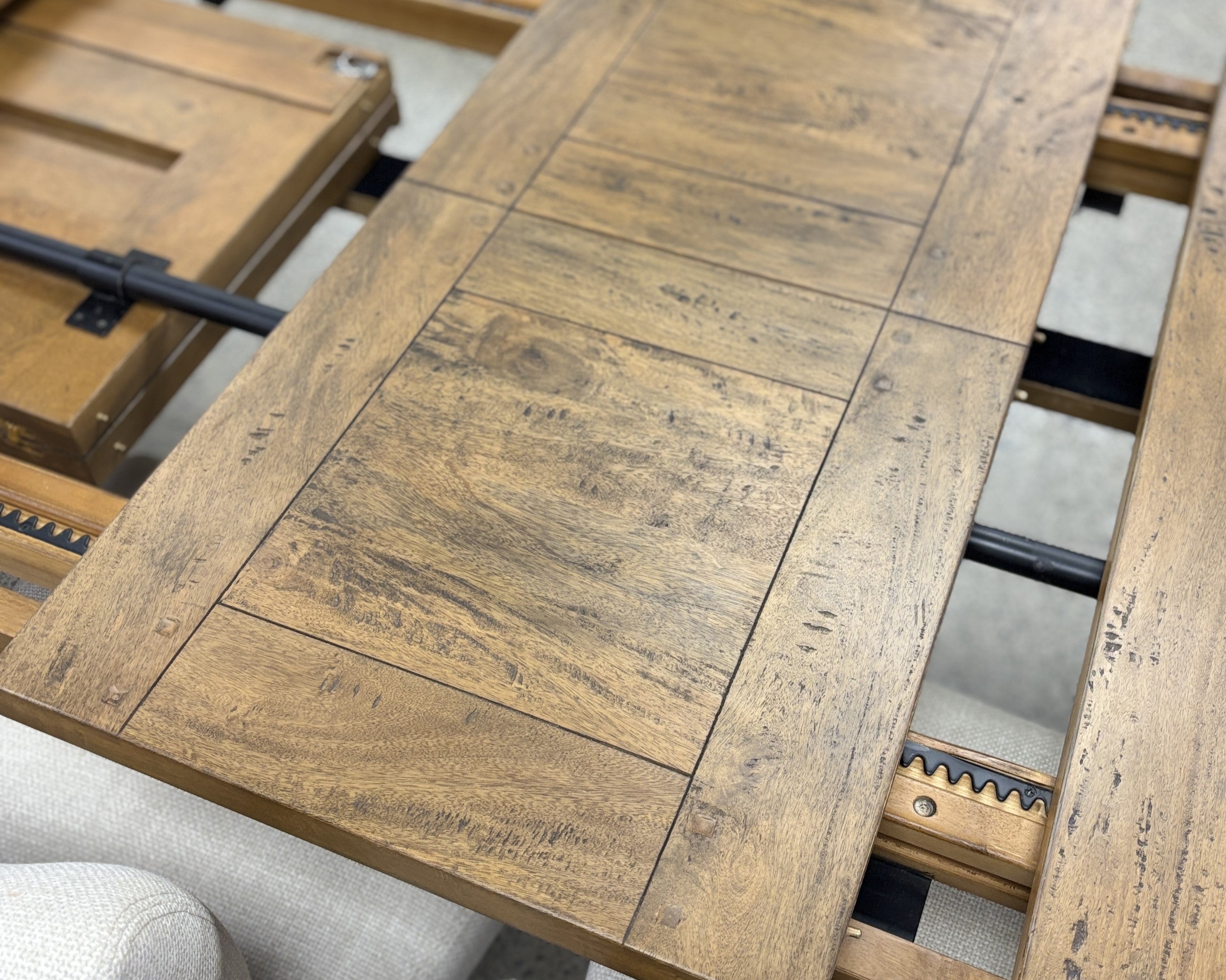 Close-up of the Double Leaf Extension Table's solid mango wood extension leaves, highlighting the matching timber grain and rustic finish.