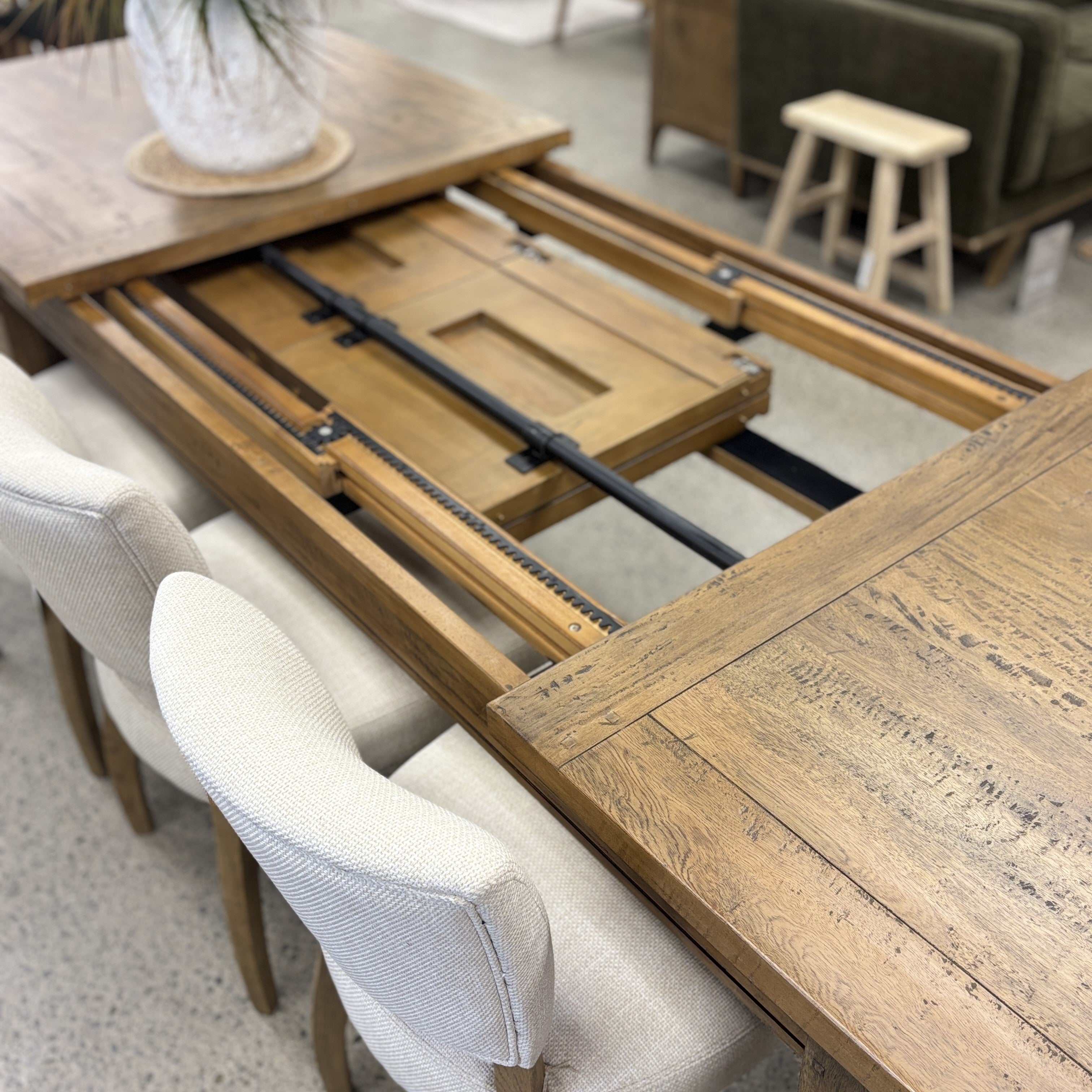 Close-up of the Double Leaf Extension Table's smooth chain-driven extension mechanism, designed for effortless opening and closing.