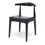 Black Elbow Dining Chair angled view showing sculpted curved back and black PU seat