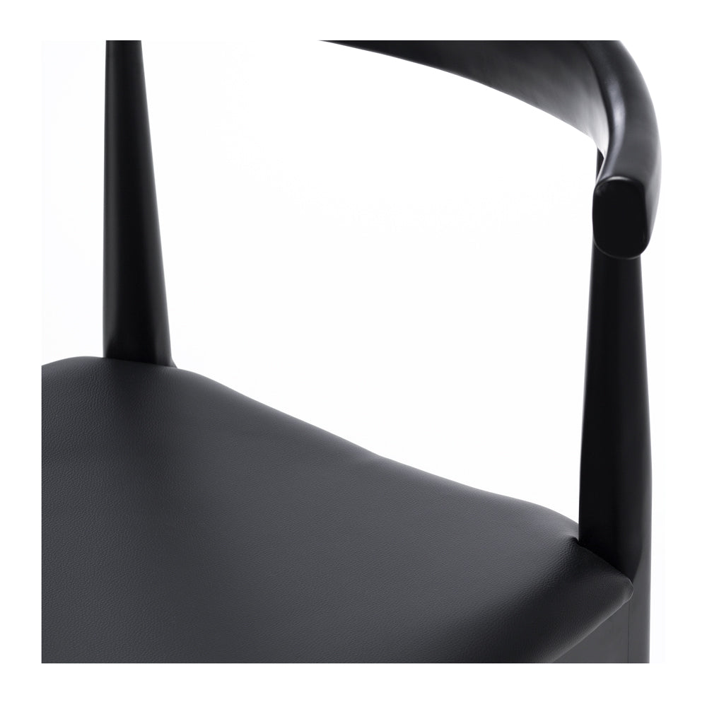 Close up of Elbow Dining Chair Black showing black oak finish and curved timber frame