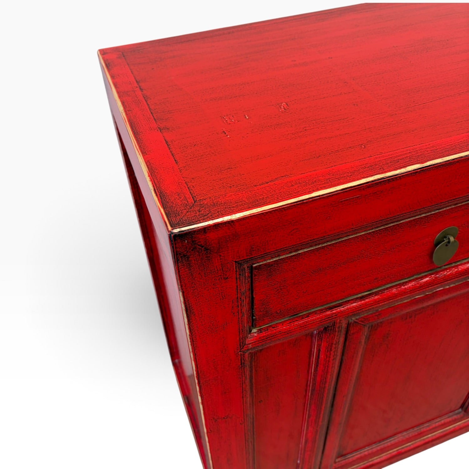 Close-up of the Elliot Sideboard top showing the hand-finished Chilli red surface and aged detailing