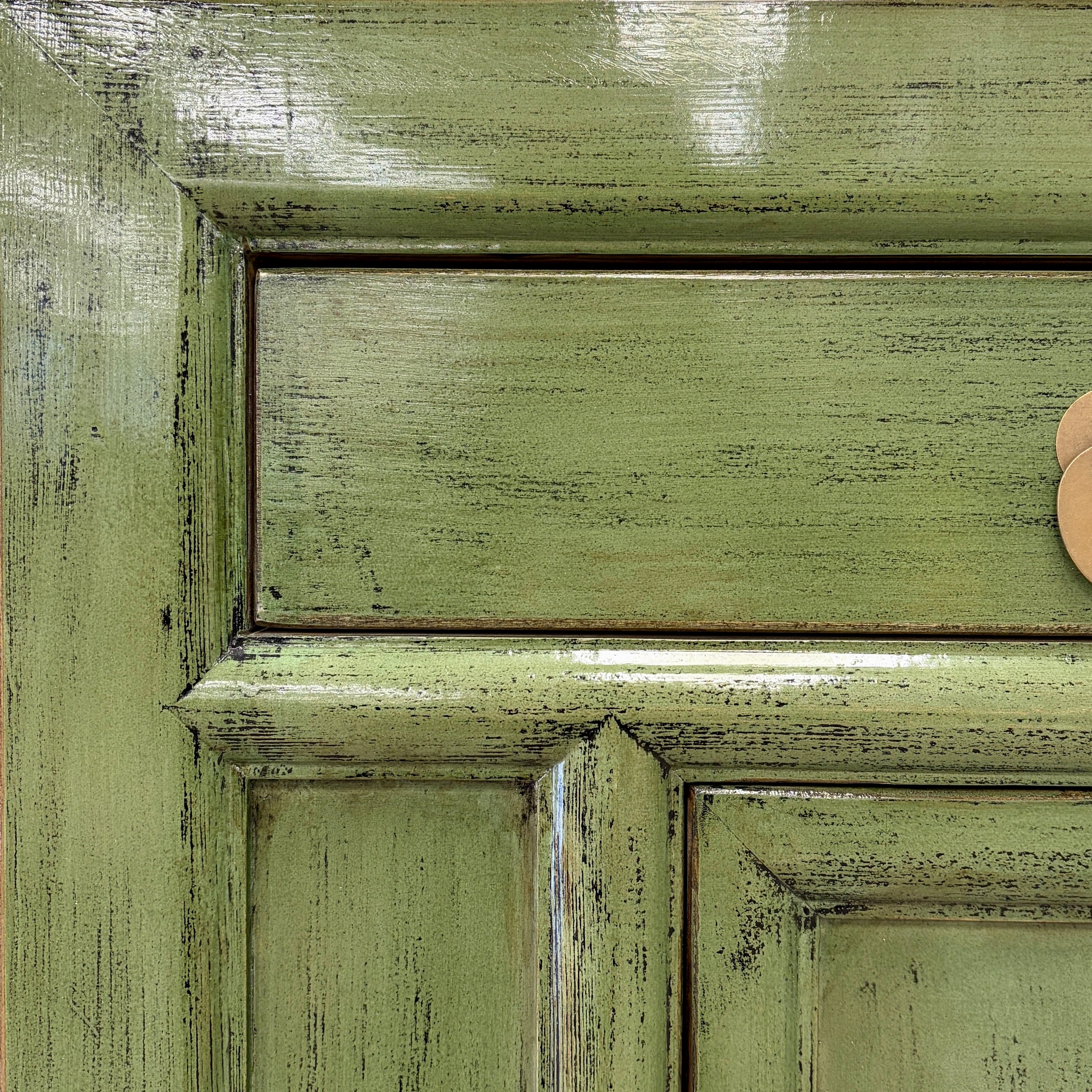 Close up of Elliot Sideboard showing textured olive green finish and brass toned hardware