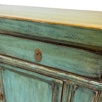 Close-up of the textured distressed sea green finish and drawer detail on the Elliot Sideboard