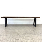 Front view of the Evolution Albany mango wood bench seat with black iron legs