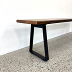 Detail of the Evolution Albany bench seat showing the black iron leg and mango wood seat
