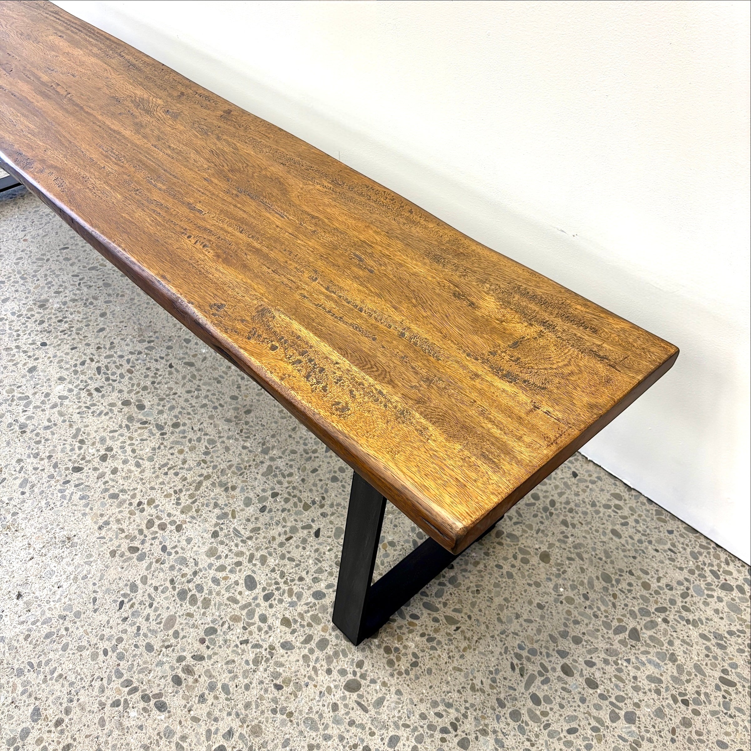 Close-up of the Evolution bench seat showing the natural grain and character of the Albany mango wood