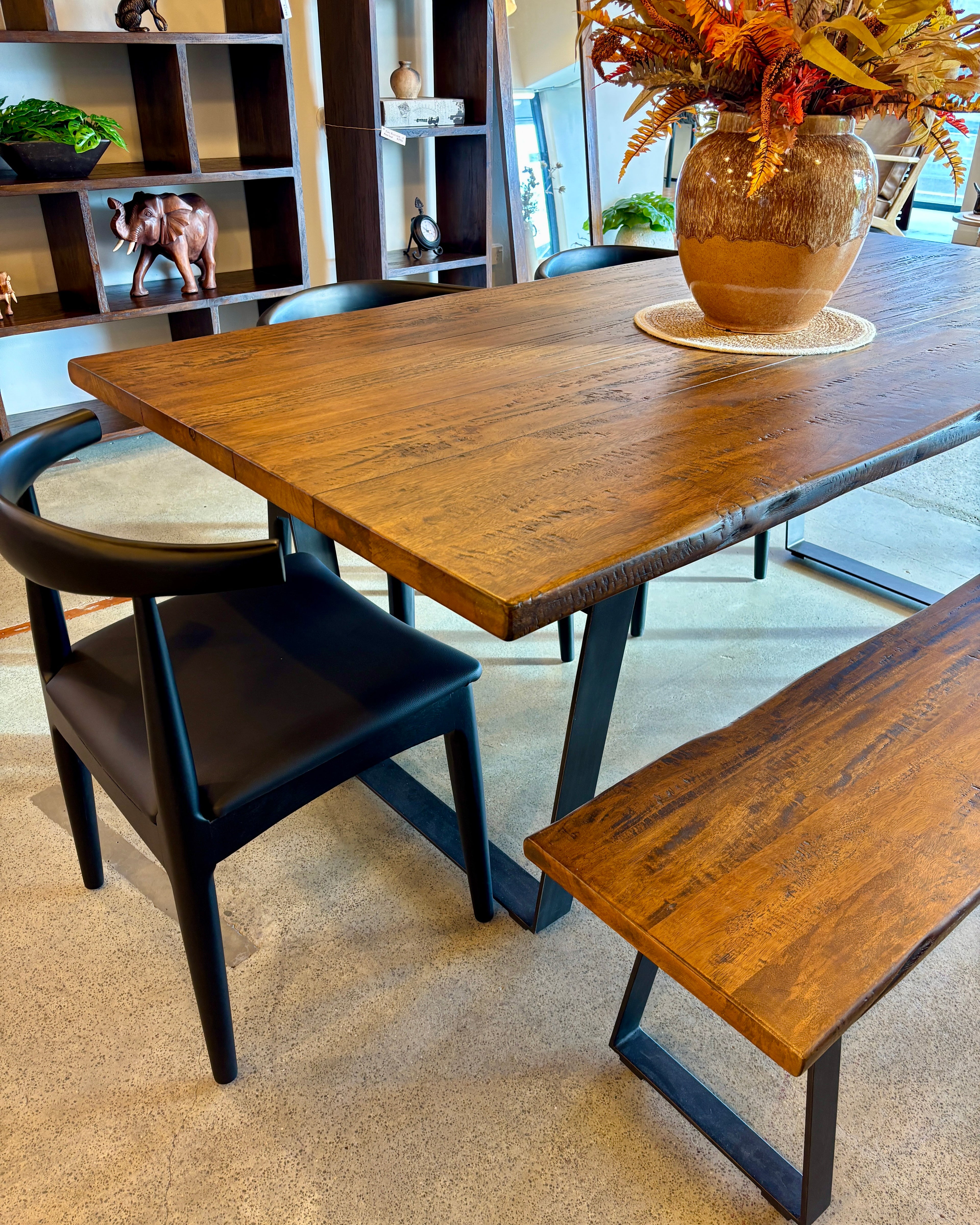 Angled view of the Evolution Rectangular Dining Table in Albany, highlighting the solid mango wood construction, freeform tabletop and contemporary design.