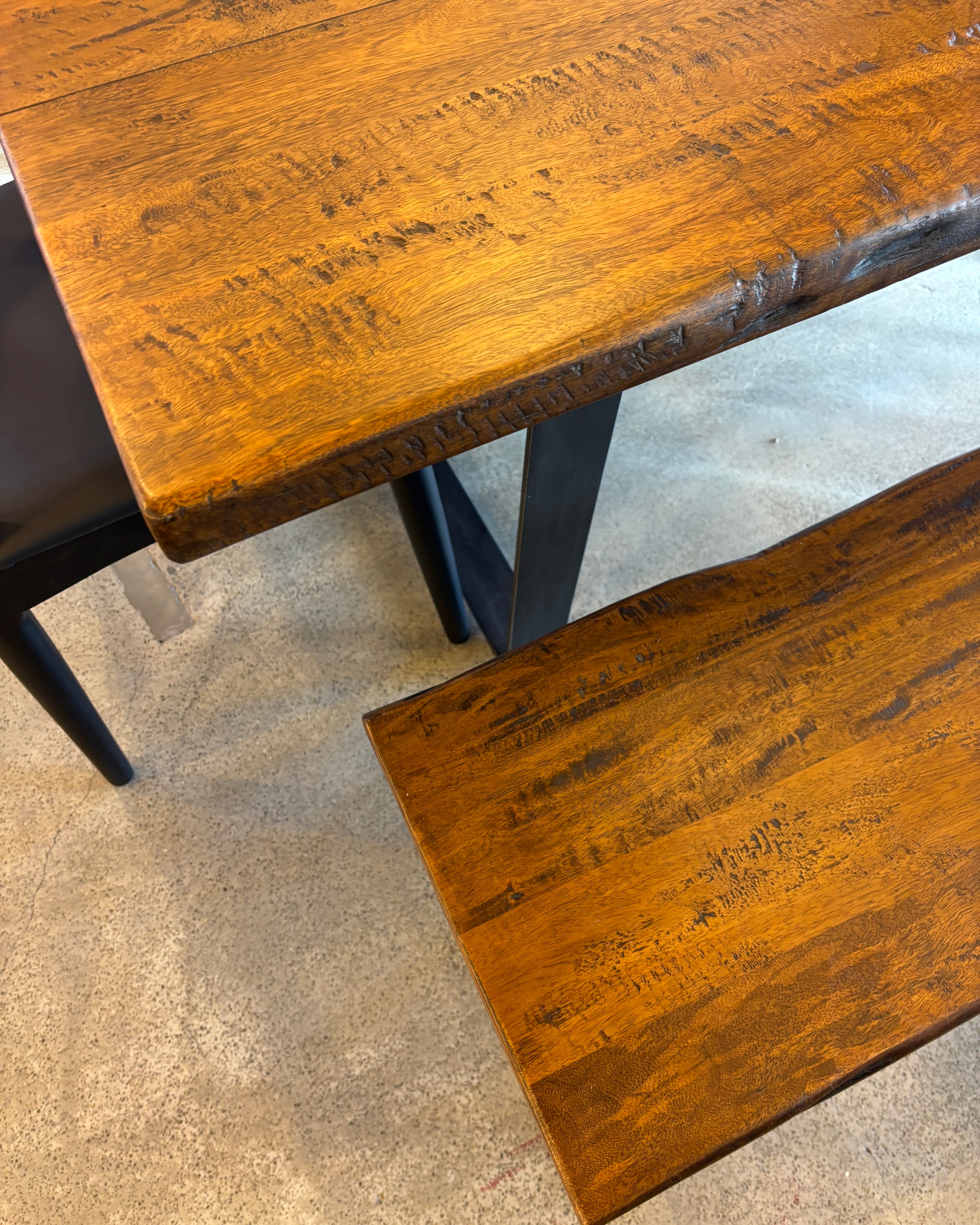 Close-up of the Evolution Rectangular Dining Table, showcasing the natural mango wood grain, rustic finish and handcrafted freeform edge.