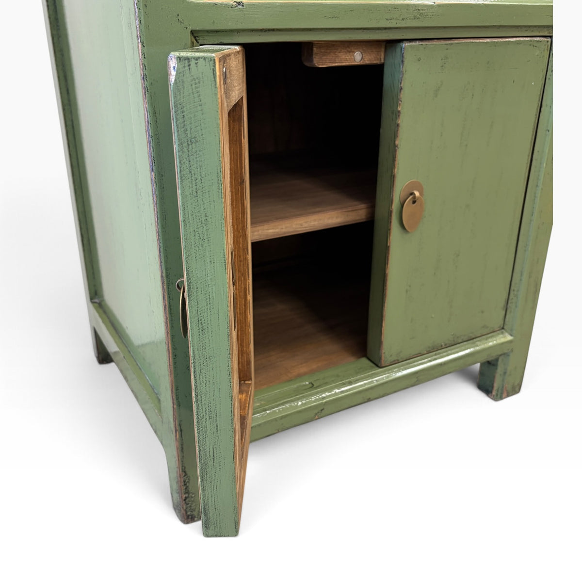 Angled view of Far East Bedside in Olive with brass-toned drop handles and rustic detailing