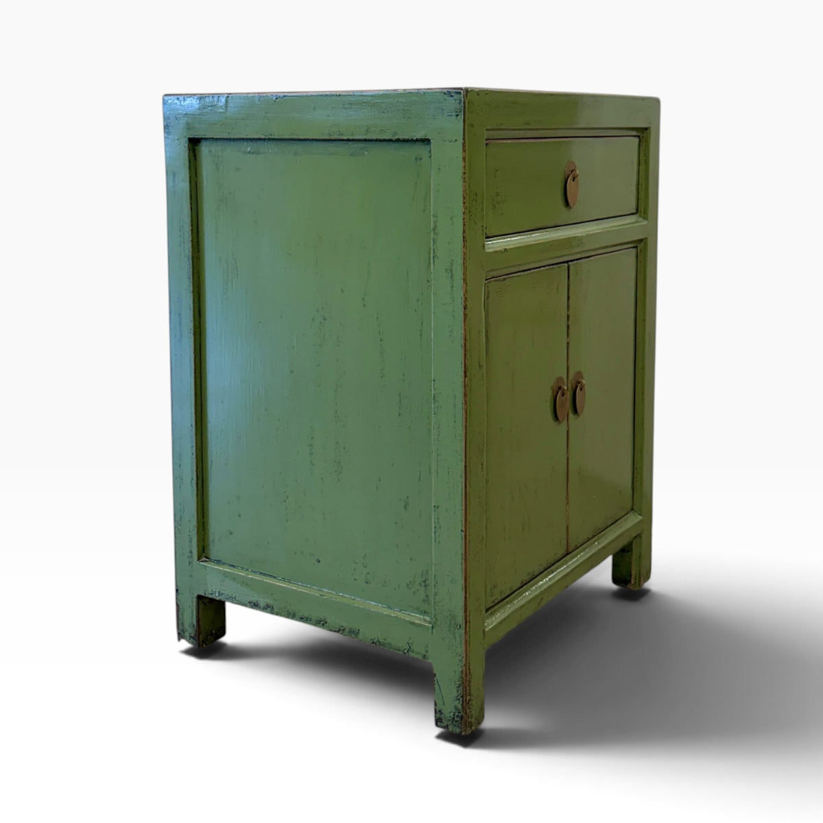 Angled side view of Far East Bedside showing distressed olive green finish and panelled sides