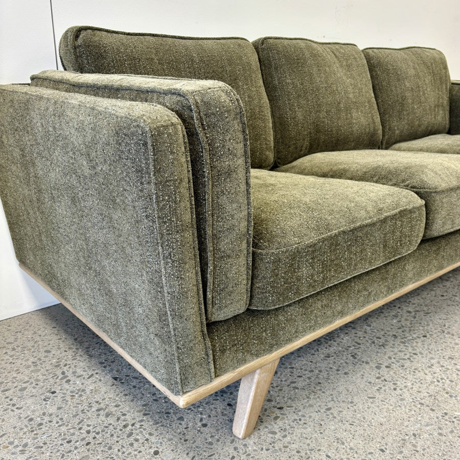 Side profile of the Fergus 3 Seat Sofa in Plush Olive, showcasing its generous proportions, supportive cushions and clean contemporary lines.