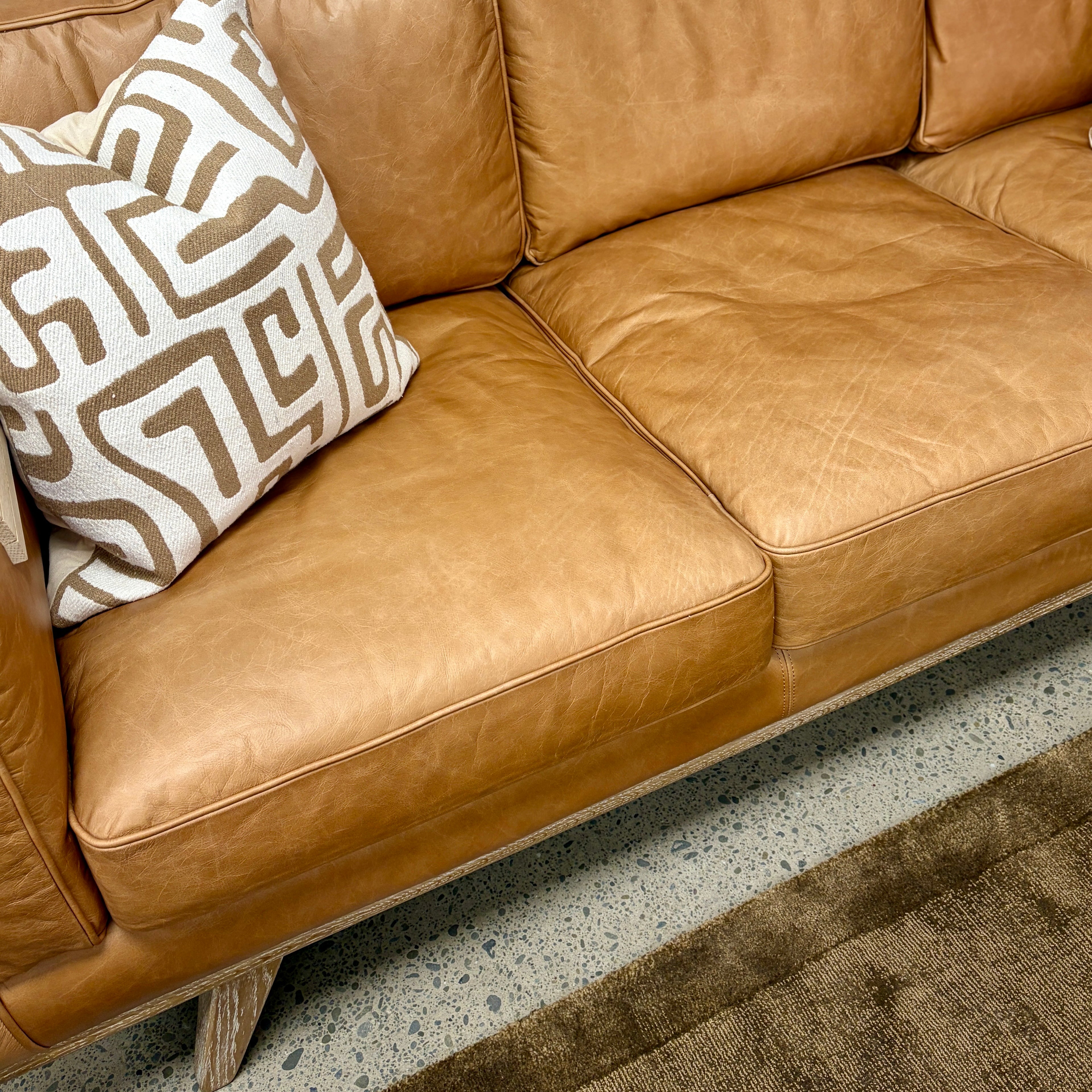Close-up of the Fergus Sofa's premium Toffee leather cushions, highlighting the natural leather grain and quality finish.