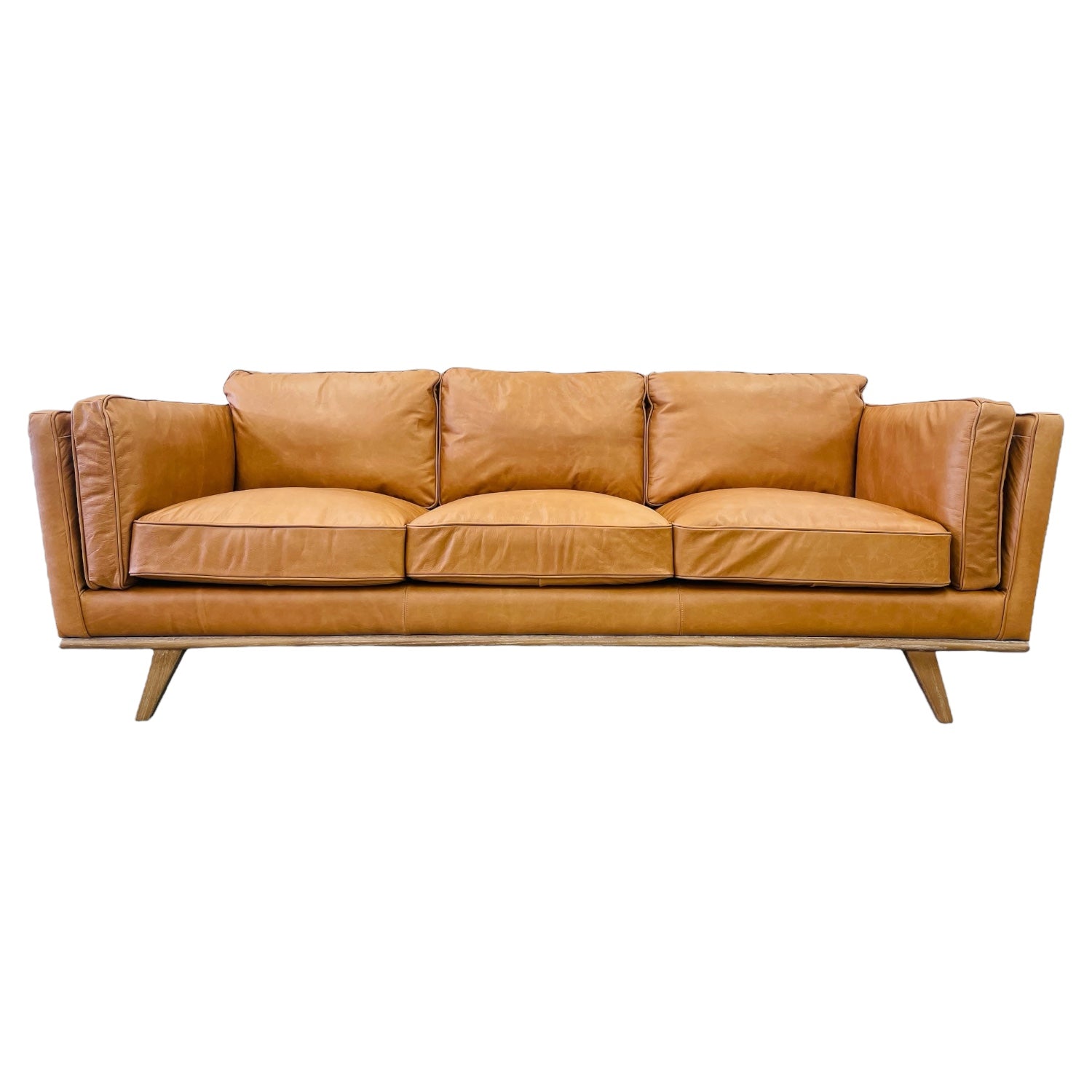 Fergus Sofa in Toffee leather with clean contemporary lines, premium leather upholstery and solid oak legs.