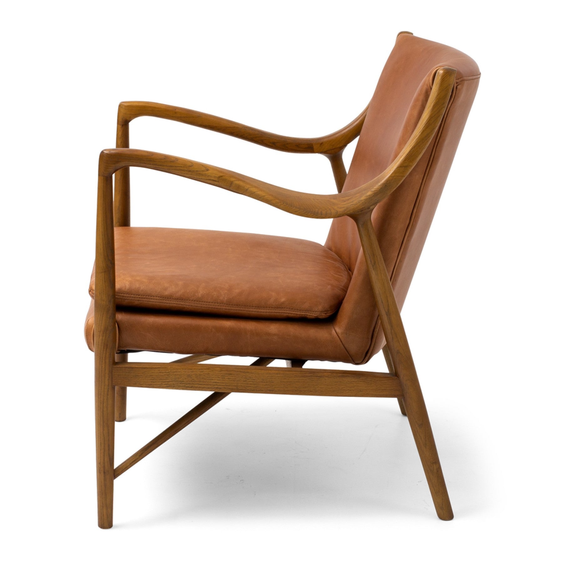 Side profile of the Finn Occasional Chair in Tan with a curved ash timber frame and top-grade aniline leather seat.