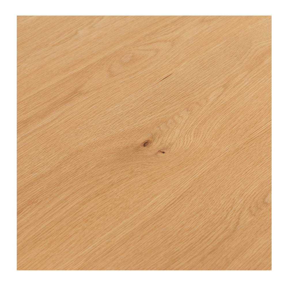 Close-up of the Flow Dining Table's solid oak tabletop, highlighting the natural timber grain and protective matt finish.