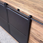 Close-up of the black iron sliding doors and rail on the reclaimed oak Forged Iron Sideboard