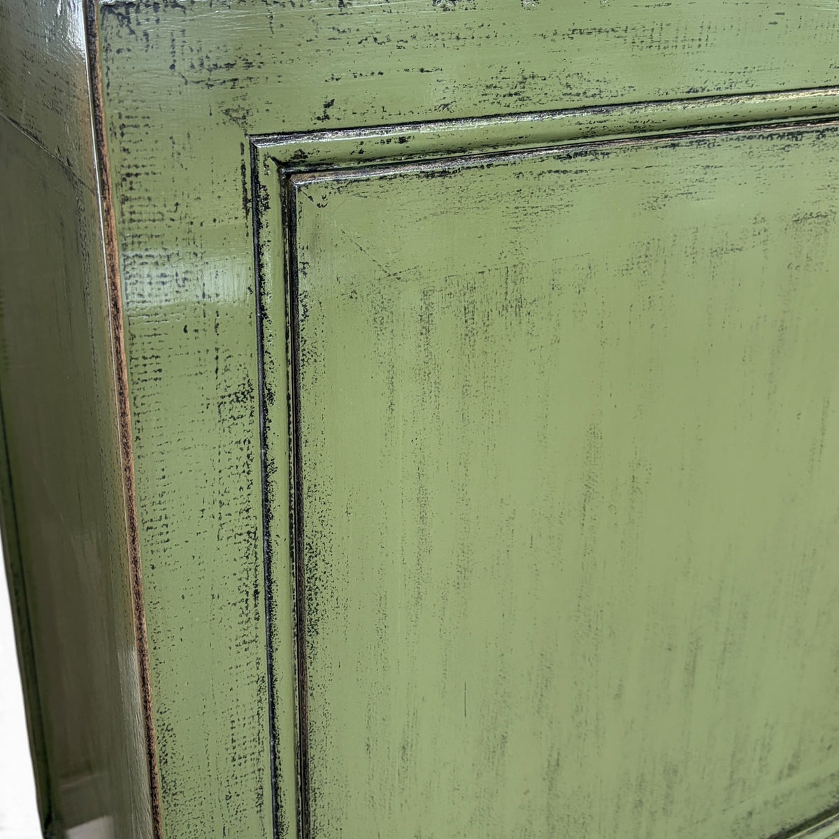 Detailed view of Frano Sideboard's olive green finish with dark distressed edging
