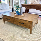 Hamstead Coffee Table crafted from solid mango wood with two drawers, styled in a contemporary living room.