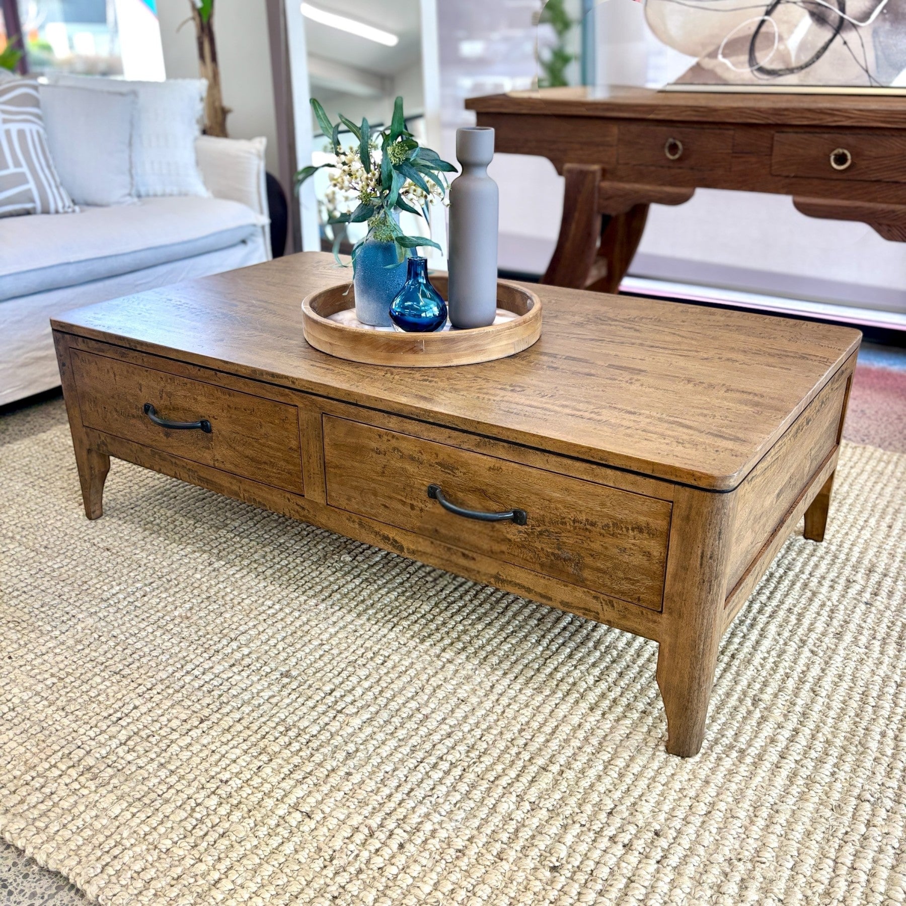 Hamstead Coffee Table crafted from solid mango wood with two drawers, styled in a contemporary living room.