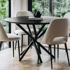 Harper round dining table in Black Oak styled in a contemporary dining room.