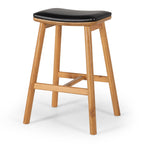 Angled view of Hue Bar Stool with black upholstered seat and natural oak frame
