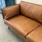 Angled view of the Hunter Leather Sofa in Caramel, highlighting its boxed frame, premium leather upholstery and contemporary silhouette.