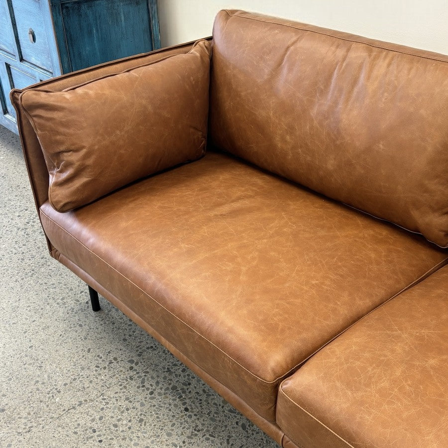 Angled view of the Hunter Leather Sofa in Caramel, highlighting its boxed frame, premium leather upholstery and contemporary silhouette.