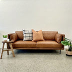 Hunter Leather Sofa in Caramel styled in a contemporary living room, showcasing its warm leather finish and modern design.