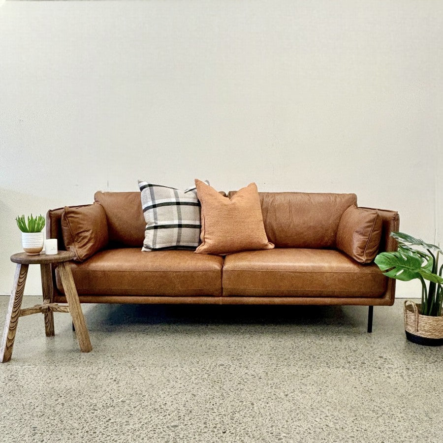Hunter Leather Sofa in Caramel styled in a contemporary living room, showcasing its warm leather finish and modern design.