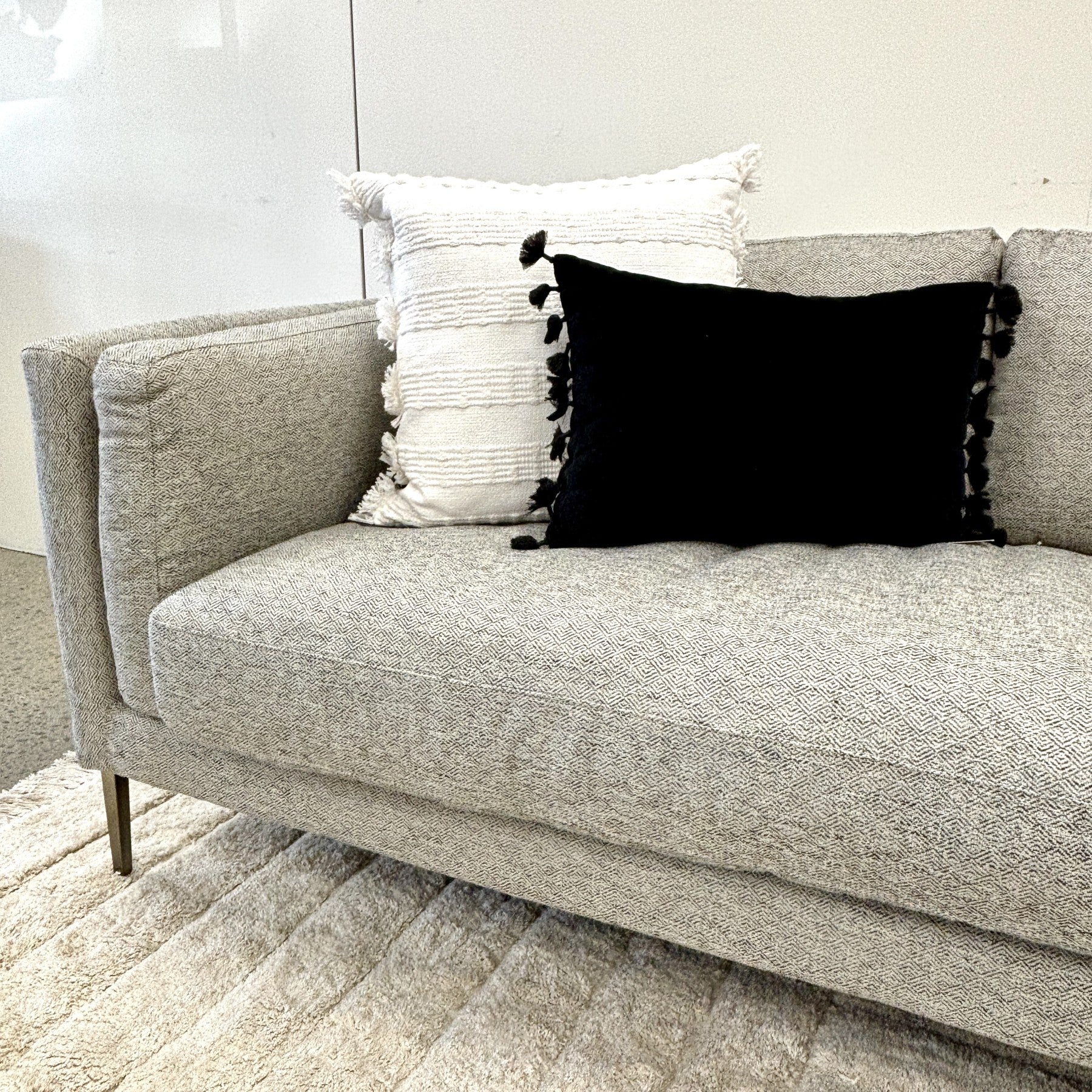 Angled styled view of the Josephine Sofa in Geo Black/White, highlighting its tailored cushions, textured upholstery and contemporary design.