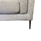 Close-up of the Josephine Sofa's slim black metal leg, showcasing the elevated contemporary design.