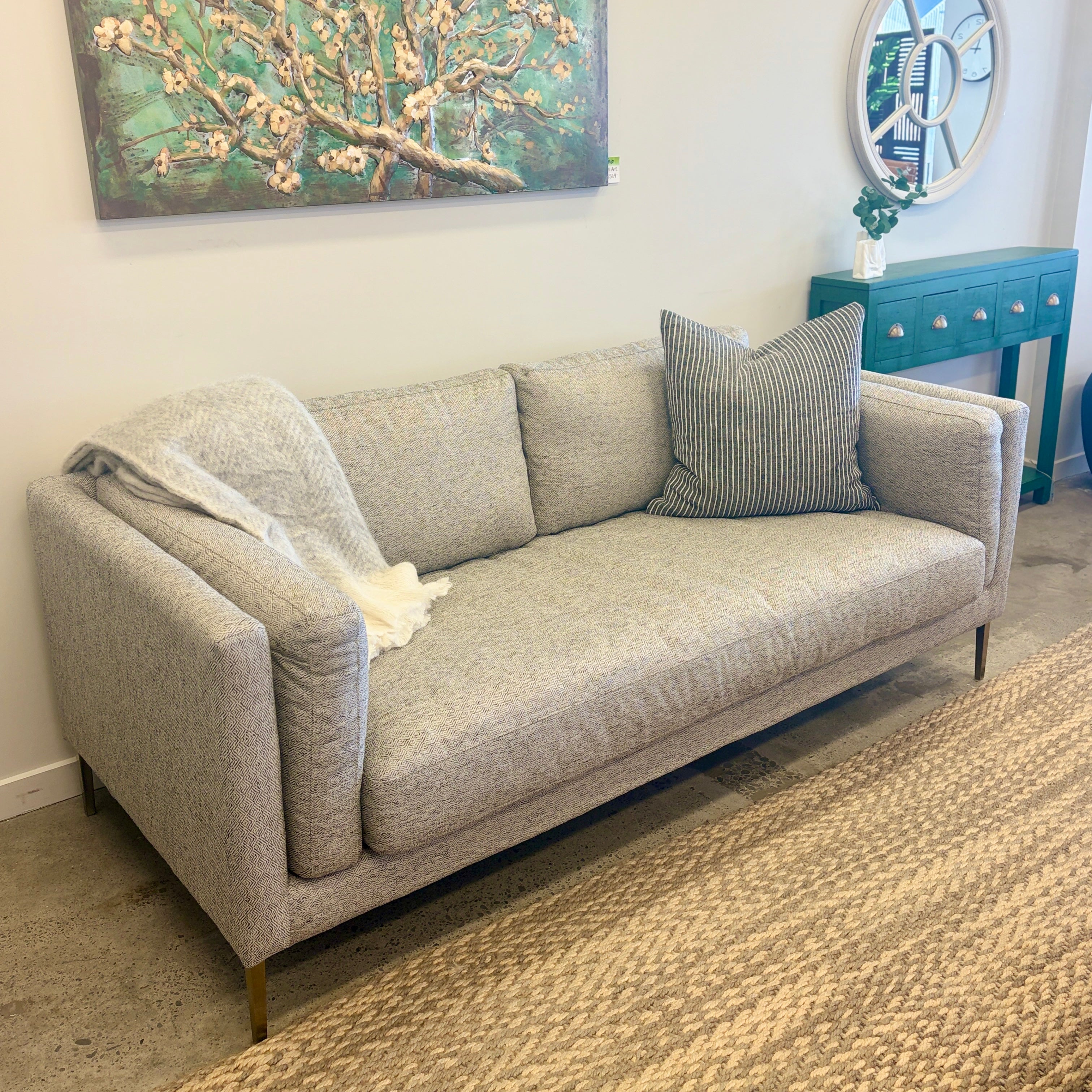 Josephine Sofa in Geo Black/White displayed in the Java Furniture showroom, showcasing its contemporary design and elevated black metal legs.