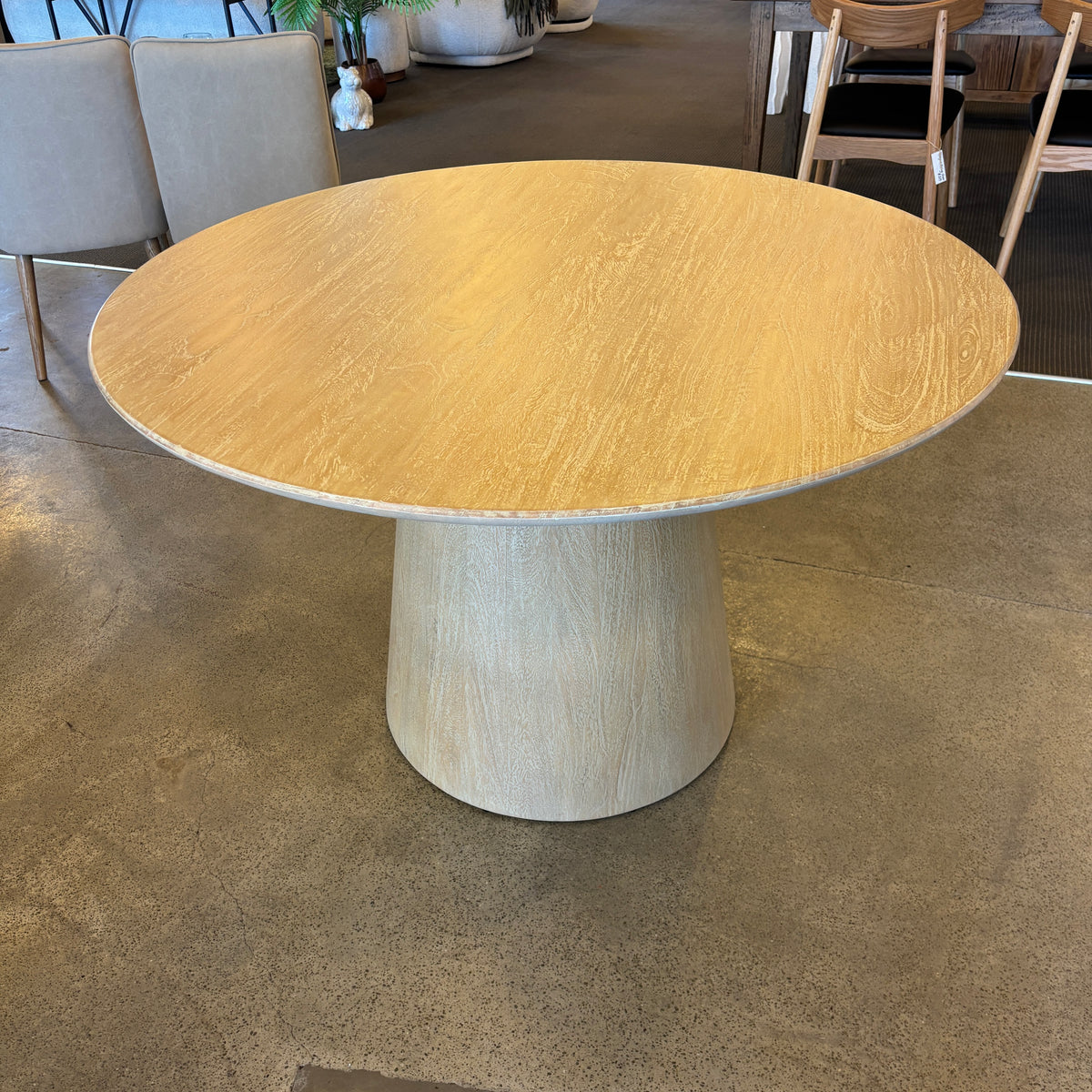 Overhead view of the Lando Dining Table, highlighting the spacious round tabletop and distinctive timber grain in the Sandblast finish.