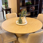 Angled view of the Lando Dining Table, showcasing the generous round tabletop and statement pedestal base in the Sandblast finish.