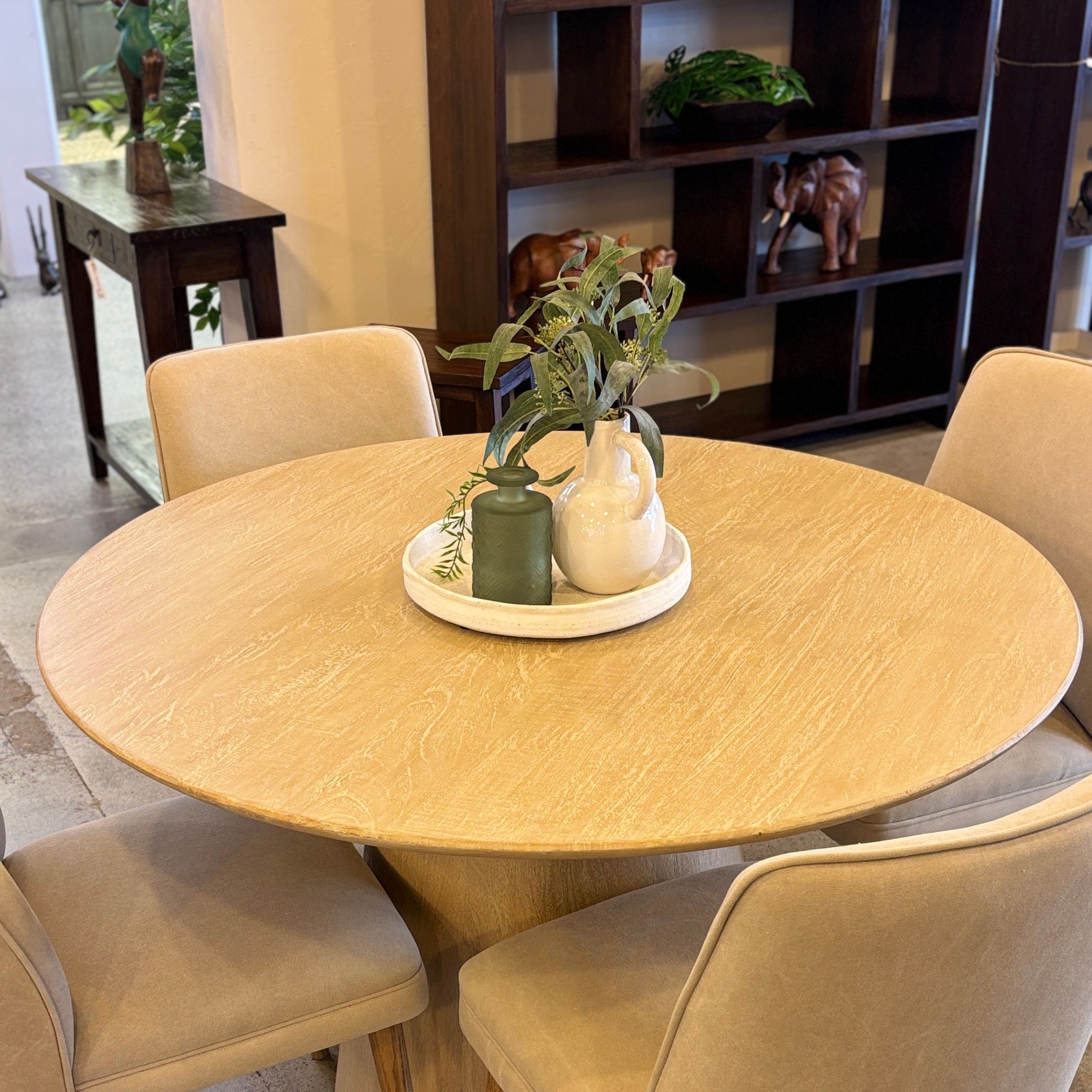 Angled view of the Lando Dining Table, showcasing the generous round tabletop and statement pedestal base in the Sandblast finish.