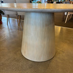 Close-up of the Lando Dining Table's tapered pedestal base, crafted from solid mango wood and finished in a soft Sandblast tone.
