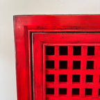 Close-up of the distressed red finish and lattice detailing on the Lattice 2 Door Cupboard