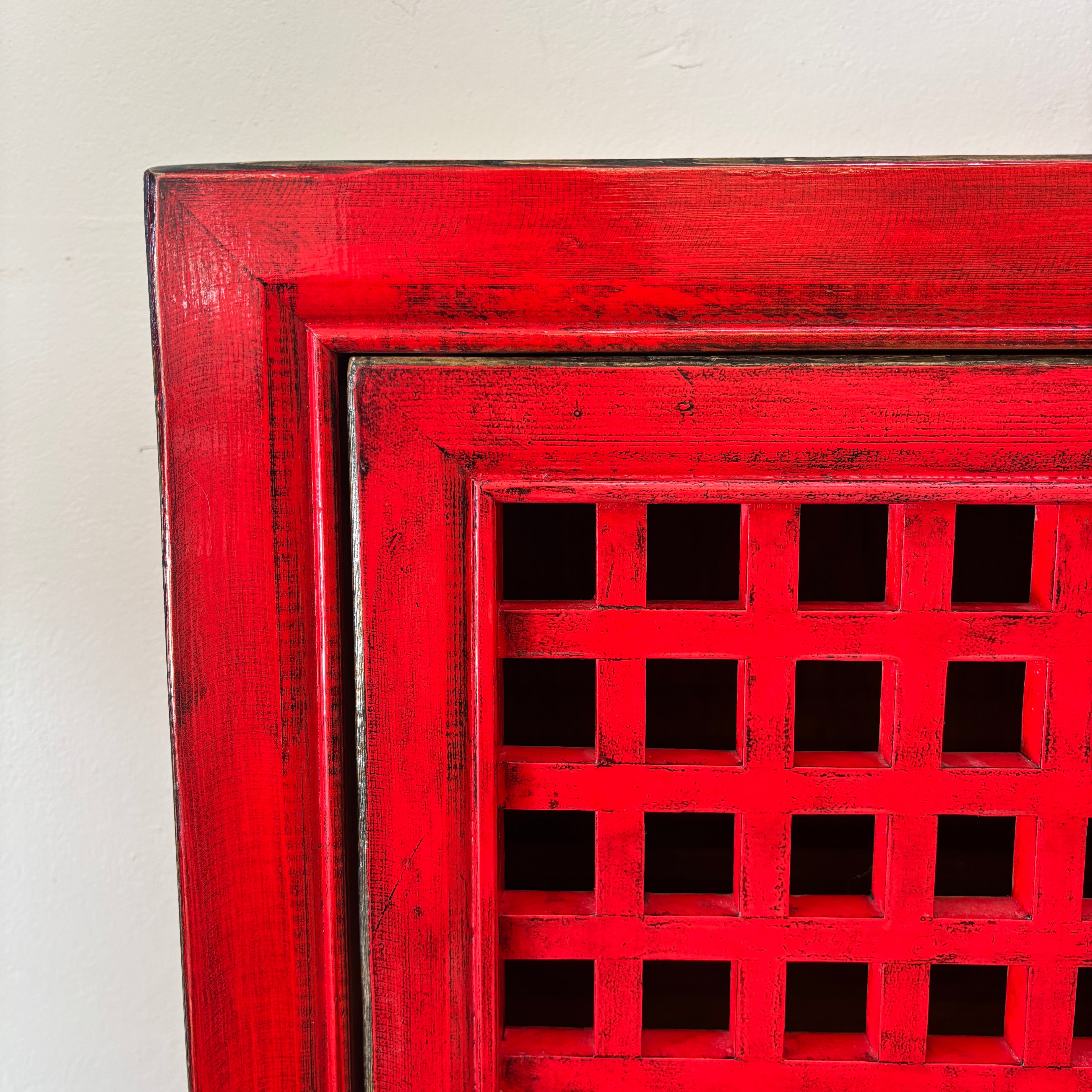 Close-up of the distressed red finish and lattice detailing on the Lattice 2 Door Cupboard