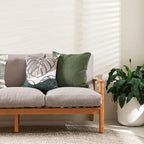 Liana Cushion in olive styled with green cushions on a neutral sofa