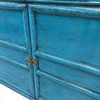 Close-up of Lola Sideboard panelled doors with brass-toned ring handles and aged blue finish