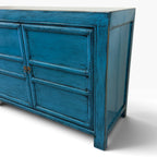 Angled view of Lola Sideboard showing decorative panel detailing and distressed sky blue finish