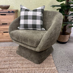 Lolo Swivel Chair in Cocoa styled in a contemporary living room with complementary furniture and décor.
