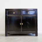 Loui Sideboard in Black showing lacquered pine finish, two drawers and panelled cupboard doors