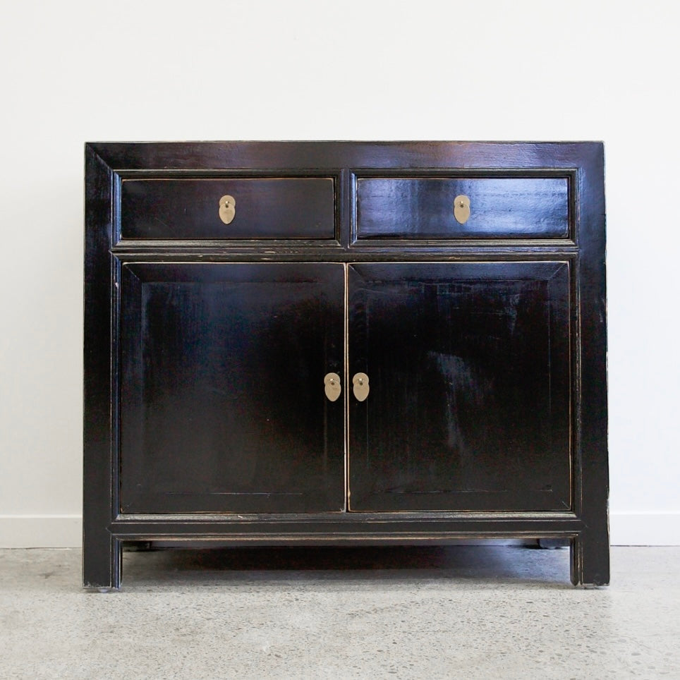 Loui Sideboard in Black showing lacquered pine finish, two drawers and panelled cupboard doors