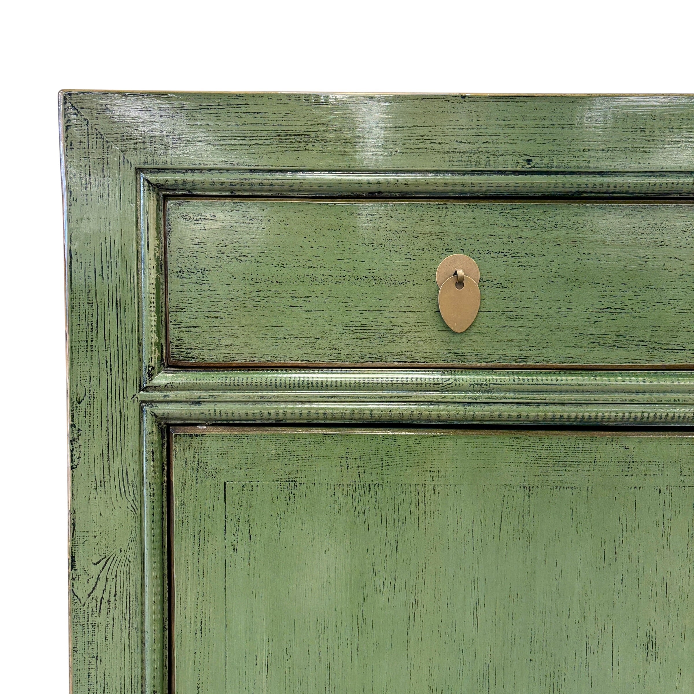 Close-up of the textured olive green finish and brass-toned hardware on the Loui Sideboard