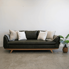Lucca Sofa in Moss Green leather styled in a contemporary interior, showcasing its rich colour and refined silhouette.