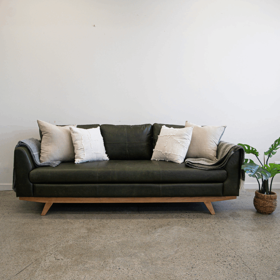 Lucca Sofa in Moss Green leather styled in a contemporary interior, showcasing its rich colour and refined silhouette.