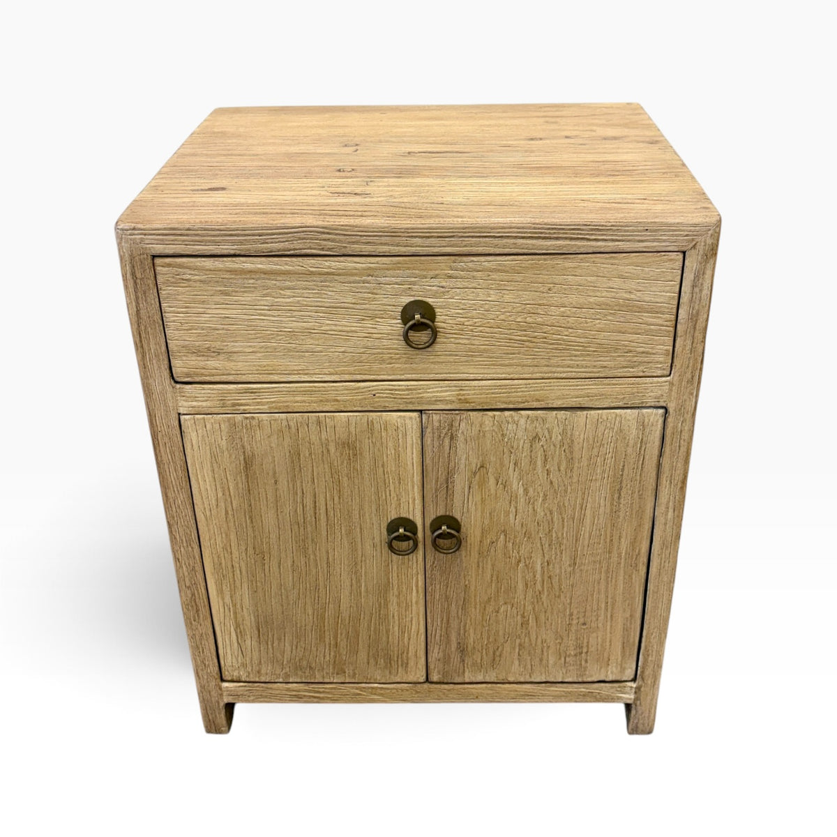 Angled front view of the Lydia Elm Bedside showing the timber top, drawer and double-door cupboard